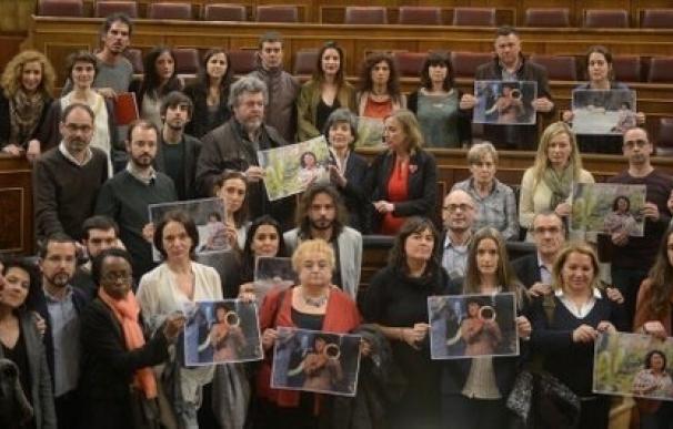Diputados Podemos se solidarizan con Berta Cáceres (indígena asesinada) mostrando fotos en el Hemiciclo tras el debate