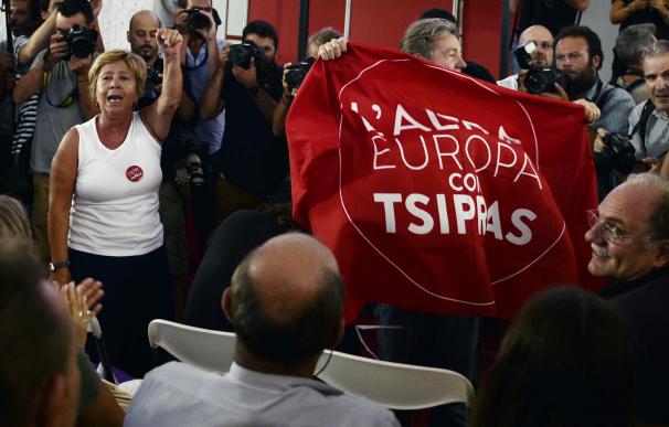 Syriza supporters react at the announcement of the