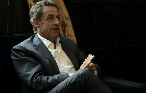French former President Nicolas Sarkozy speaks wi