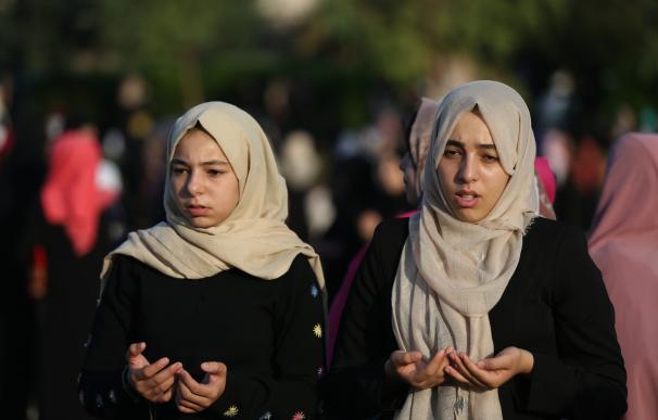 Palestinian women perform the morning prayer of the Muslim holiday of the Eid al-Adha on September 12, 2016, in Gaza