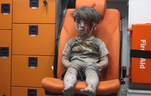 Omran Daqneesh, de cinco años, se sienta en una ambulancia tras haber sufrido varias heridas después de un ataque aéreo en un barrio de Alepo.