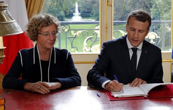 El presidente francés, Emmanuel Macron (d), firma la reforma para flexibilizar el mercado laboral, una de las principales promesas de su programa ( EFE/Philippe Wojazer )
