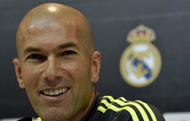 Real Madrid's new French coach Zinedine Zidane smi