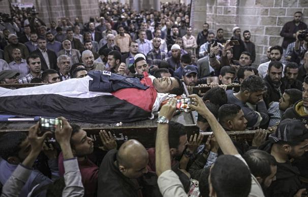Palestinos portan el cuerpo del reportero Yasser Mourtaja, de 30 años, durante su funeral en Gaza el 7 de abril (EFE/EPA/MOHAMMED SABER)