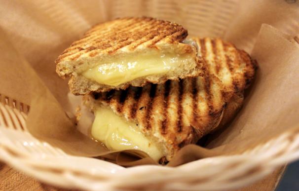 Fotografía de un sandwich con queso fundido.