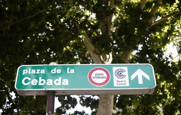 Señal de dirección de la Plaza de la Cebada con símbolo de prohibido aparcar al lado del distintivo de Madrid Central.