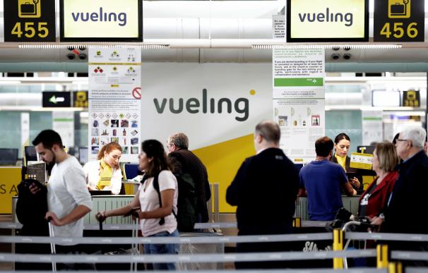 Un grupo de pasajeros ante un mostrador de facturacion de Vueling en el Aeropuerto de Barcelona-El Prat el pasado 25 de abril ( EFE/ Alberto Estévez)