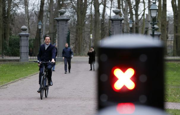 El primer ministro holandes, Mark Rutte, acude en bicicleta a presentar su dimisión antes de las elecciones