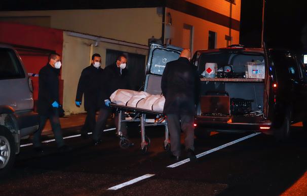 Operarios de una funeraria llevan el cadáver de un hombre de 51 años que apareció maniatado y con una bolsa en la cabeza
