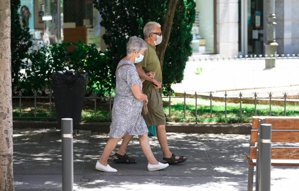 Una pareja de ancianos con mascarilla camina por la calle cogida del brazo, a 27 de julio de 2021, en Madrid, (España). La Seguridad Social destinó en el presente mes de julio la cifra récord de 10.202,29 millones de euros al pago de pensiones contributivas, lo que supone un 3,23% más que en el mismo mes de 2020. 27 JULIO 2021;ANCIANOS;MAYORES;JUBILADOS;JUBILACIÓN;PENSIÓN;PENSIONES A. Pérez Meca / Europa Press (Foto de ARCHIVO) 27/7/2021