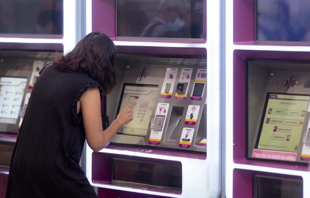 Una mujer compra su billete en las taquillas de venta automática de la estación de tren de Atocha, a 1 de septiembre de 2022,
